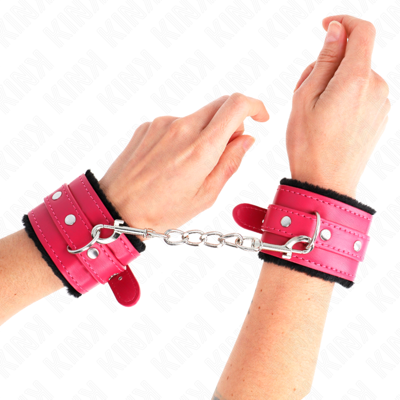 KINK - SUJECIONES DE MUÑECA CON FORRO DE PIEL PREMIUM NEGRO CON CINTURÓN ROSA FRAMBUESA AJUSTABLE 17-29 CM X 6 CM